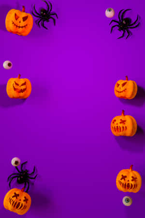 Halloween Pumpkins And Spiders On Purple Background Wallpaper