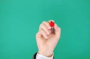 Hand Holding Red Permanent Marker Wallpaper