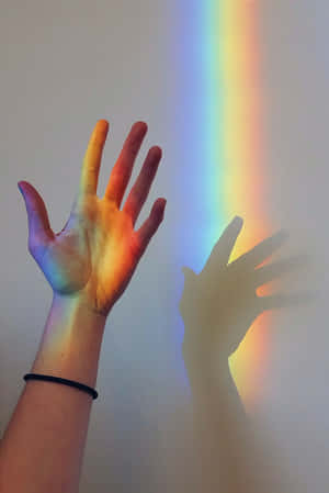 Hand Playing With The Aesthetic Rainbow Mobile Wallpaper