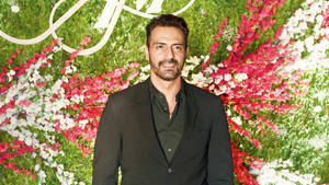 Handsome Arjun Rampal With Floral Background Wallpaper