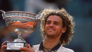 Happy Gustavo Kuerten With His Trophy Wallpaper