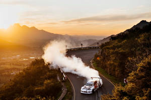 High Speed Drifting Adventure On A Mountain Road Wallpaper