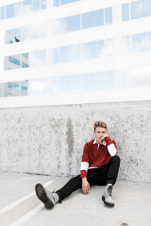 Hipster Leaning On Concrete Wall Wallpaper