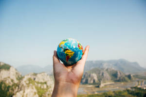 Holding An International Globe Wallpaper