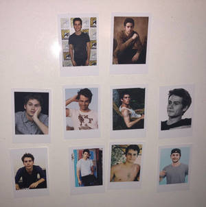 Hollywood Star Dylan O'brien Posing With Polaroid Pictures Wallpaper