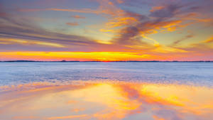 Horizon Above Reflective Water Wallpaper