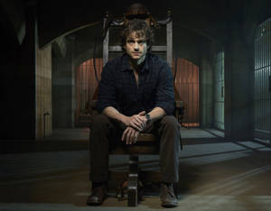 Hugh Dancy On A Chair Wallpaper