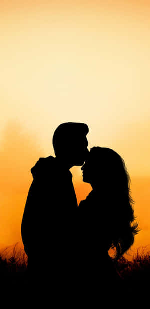 Husband And Wife Forehead Kiss Sunset Wallpaper