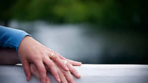 Husband And Wife Wedding Rings On Railing Wallpaper