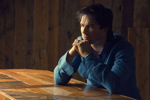 Ian Somerhalder At Wooden Table Pose Wallpaper