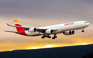 Iberia Airlines Airplane Takeoff At Sunset Wallpaper