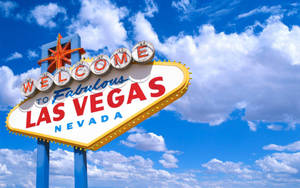 Iconic Las Vegas Strip Sign Against A Cloudy Sky Wallpaper