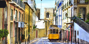 Iconic Yellow Trams Of Lisbon Wallpaper