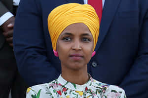 Ilhan Omar In A Yellow Hijab Wallpaper