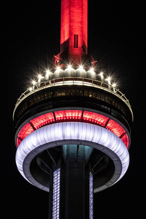 Illuminated Cn Tower Dominating Skyline At Night Wallpaper