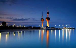 Illuminating Beauty Of Kuwait Towers At Night. Wallpaper
