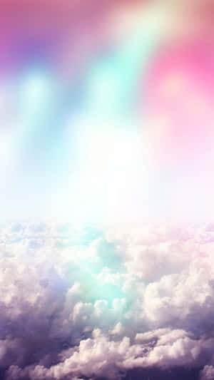 Image A Cheerful Rainbow Against A Sky Of Soft Clouds. Wallpaper