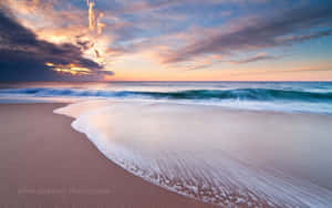 Image A Peaceful, Tranquil Beach Perfect For A Calming Getaway. Wallpaper