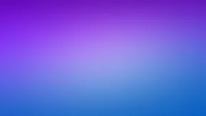 Image A Purple Laptop On A Marble Table Wallpaper