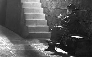 Image Charlie Chaplin In A Sad And Reflective Portrait Wallpaper