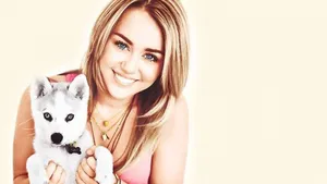 Image Delightful Miley Cyrus Enjoying Time With Her Puppy Wallpaper