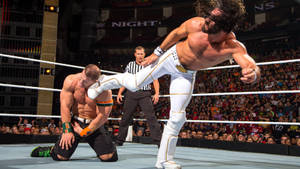 Image Two Wrestlers Performing A Kick-off At A Professional Wrestling Event Wallpaper