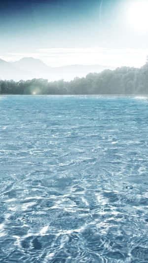 Immerse Yourself In The Perfect Blend Of Nature And Technology With This Water Iphone Wallpaper. Wallpaper