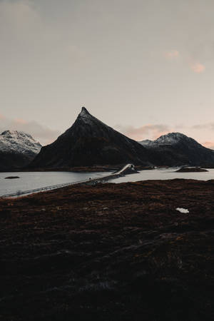 In The Majestic Lofoten Islands, A Bridge Crosses The Mesmerizing Fjord Mountains. Wallpaper