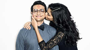 Indian Guy Kissed By A Gorgeous Woman Wallpaper