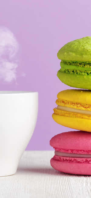 Indulge In The Rainbow - Vibrantly Colored Macarons Stacked Elegantly Wallpaper