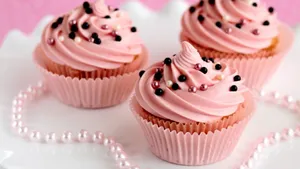 Indulgent Pink Cupcake With Sprinkles Wallpaper