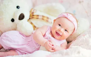 Innocence Personified: Newborn Baby Nestled Comfortably Wallpaper