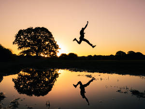 Inspirational Man Jumping On Water Wallpaper