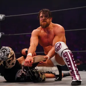 Intense Action With Bryan Danielson In A Wrestling Match Wallpaper