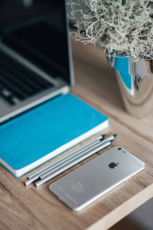 Iphone Desk Close Up Blue Journal Wallpaper