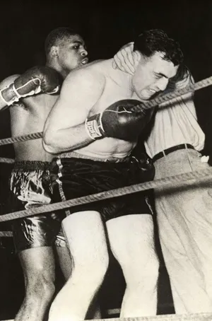 Italian Boxer Primo Carnera Holding On To The Ropes Wallpaper