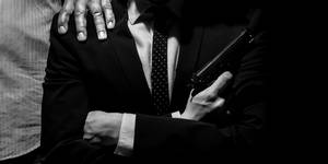 Italian Mafia Holding A Gun Wallpaper