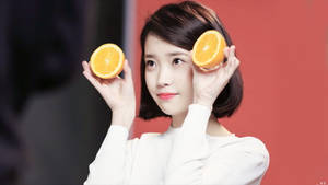 Iu Presenting An Orange Wallpaper