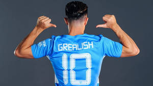 Jack Grealish Pointing At His Name On His Football Jersey Wallpaper