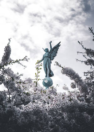 Japanese Angel Statue In Full Bloom Wallpaper