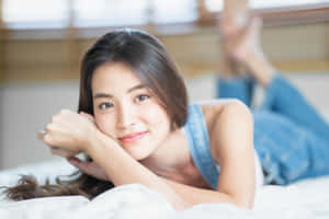 Japanese Women Lying On Bed Wallpaper