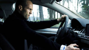 Jason Statham Driving A Car Wallpaper