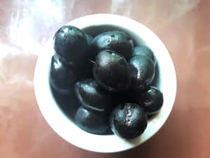 Java Plums Glossy Wooden Table Wallpaper