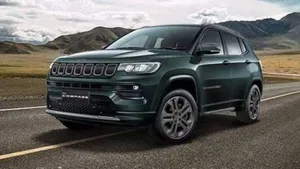 Jeep Compass Driving With Mountains Background Wallpaper