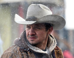 Jeremy Renner With A Cowboy Hat Wallpaper