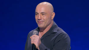 Joe Rogan Intensely Performing Stand-up Comedy Wallpaper