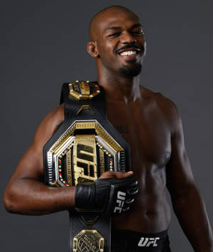 Jon Jones Smiling With Champ Belt Wallpaper