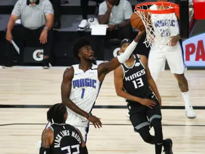 Jonathan Isaac Reaching Basketball Ring Wallpaper