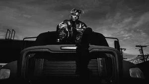 Juice Wrld In A Black And White Truck Wallpaper
