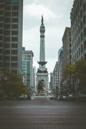 Jumping Front Of Indianapolis Monument Wallpaper